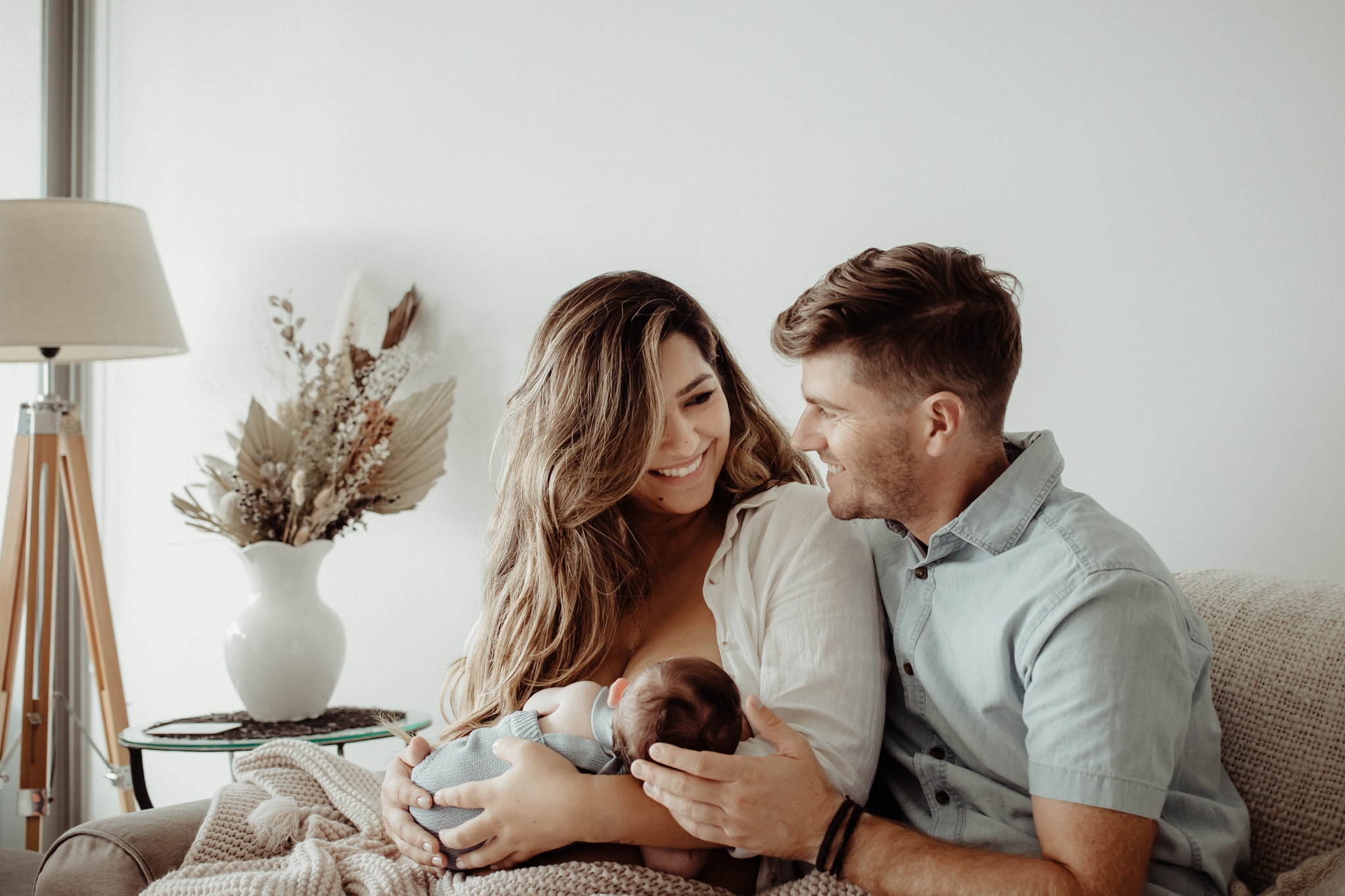 Newborn baby boy with mum and dad looking at each other